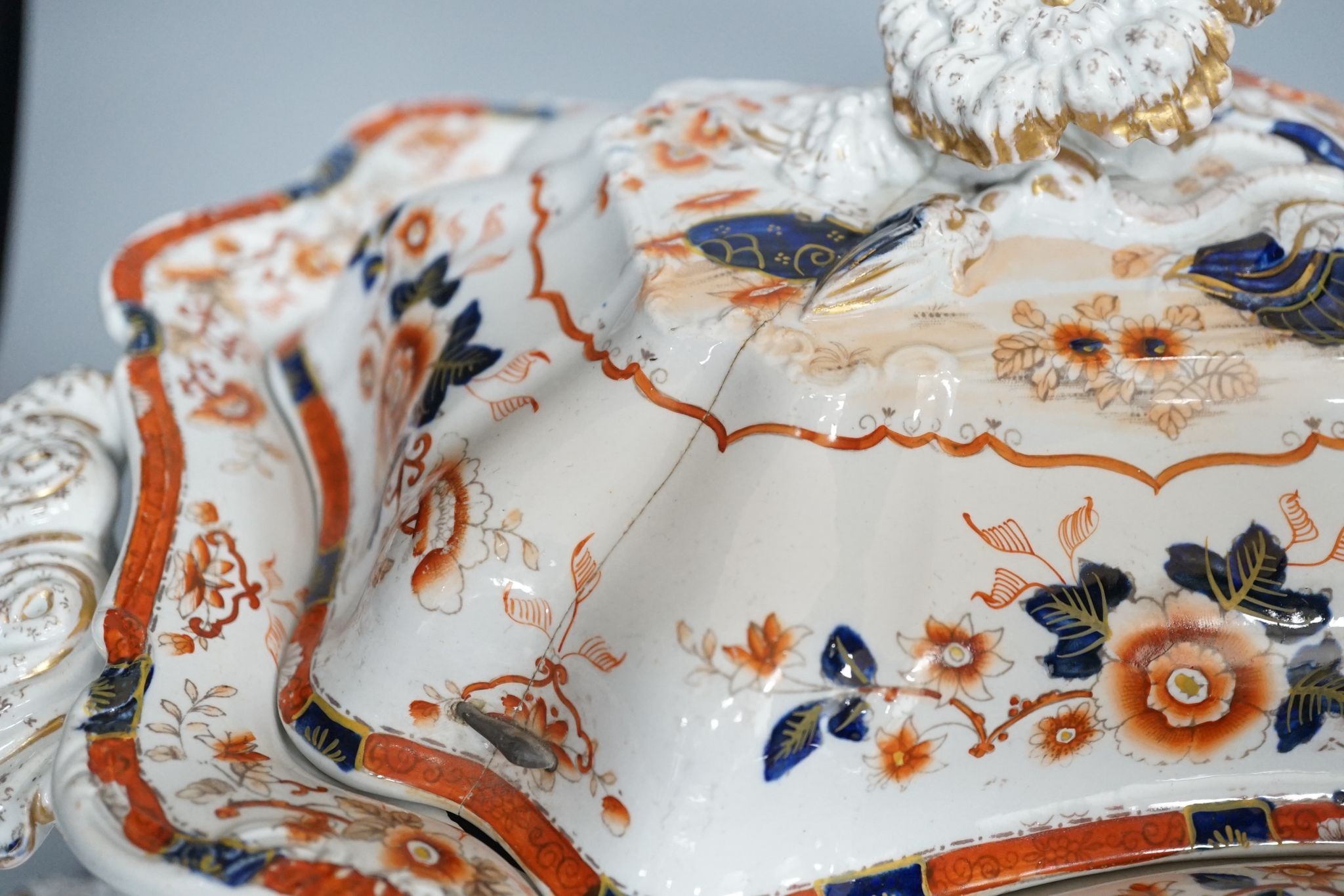 An early 19th century stone china soup tureen and cover on stand, decorated in cobalt blue and iron red, a similar tureen, a pair of small covered dishes, Staffordshire spaniels, etc.